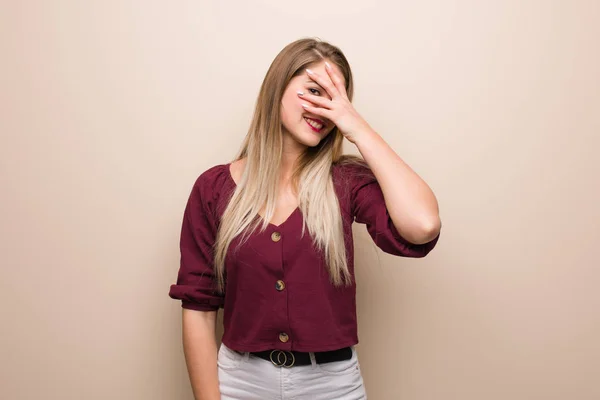 Young russian woman embarrassed and laughing at the same time