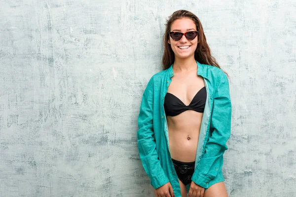 Young european woman wearing bikini and shirt