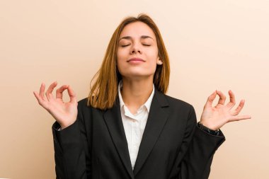 Kafkasyalı genç iş kadını sıkı çalışma gününden sonra rahatlıyor, yoga yapıyor..