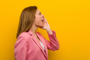 Young fashion business woman shouting and holding palm near opened mouth.