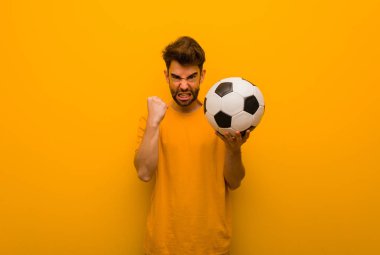 Genç futbolcu çok sinirli ve agresif bağırıyor.