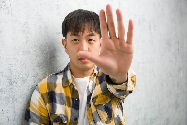 Young Chinese Man Face Closeup Putting Hand Front — стокове фото