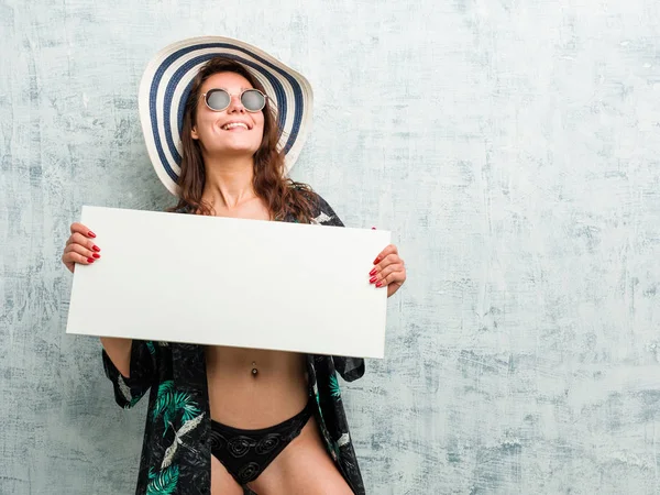 Young european woman wearing bikini and holding a placard — 스톡 사진