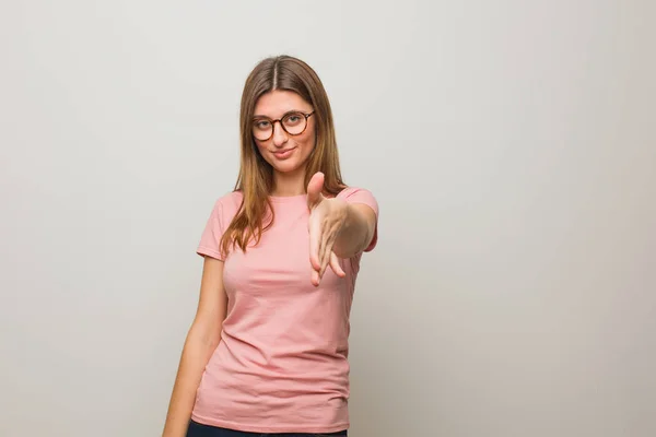 Young russian natural girl reaching out to greet someone