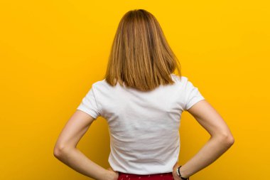 Young natural caucasian woman from behind, looking back.