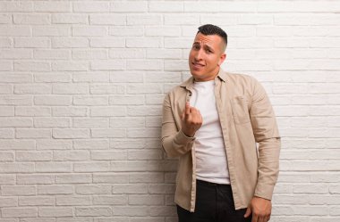 Young latin man inviting to come