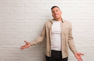 Young latin man inviting to come