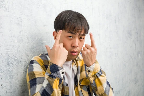Young Chinese Man Face Closeup Doing Concentration Gesture — стокове фото