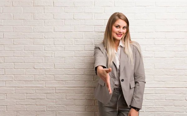 Young russian business woman reaching out to greet someone