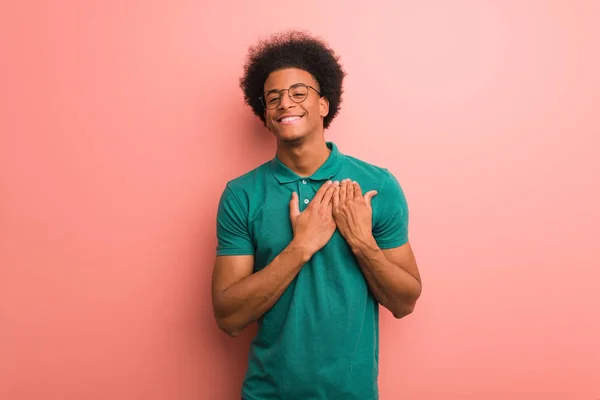 Young African American Man Pink Wall Doing Romantic Gesture — стокове фото