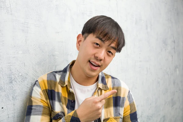 Young Chinese Man Face Closeup Smiling Pointing Side — стокове фото