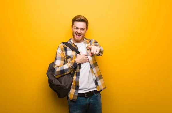 Young redhead student man dreams of achieving goals and purposes