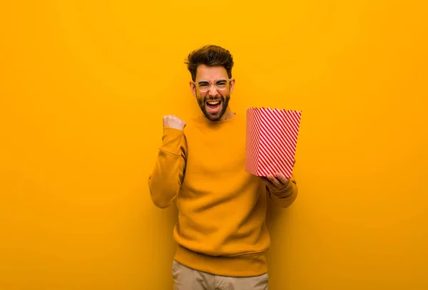 Young Man Holding Popcorns Surprised Shocked — Stock Photo, Image