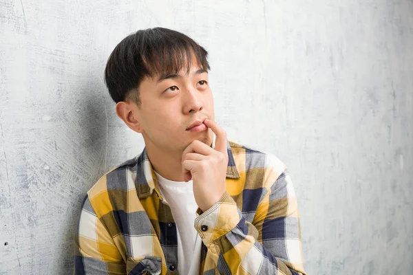 Young Chinese Man Face Closeup Doubting Confused — Stock Photo, Image