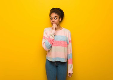 Mavi gözlü genç siyah afro-amerikan kız şüphe ve karışık