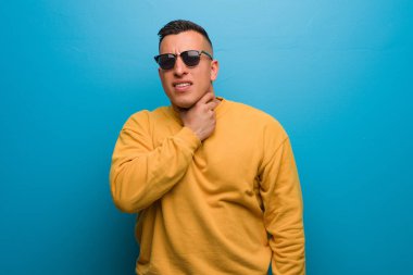 Young colombian man coughing, sick due a virus or infection