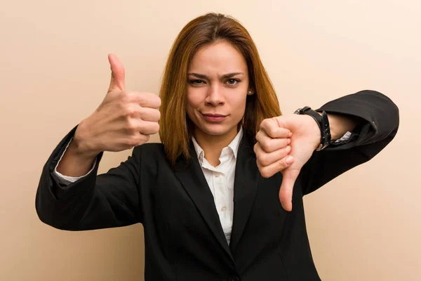親指と親指を下に示す若い白人のビジネス女性 難しい選択の概念 — ストック写真