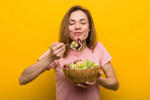 Vegan young woman eating a fresh and delicious salad.