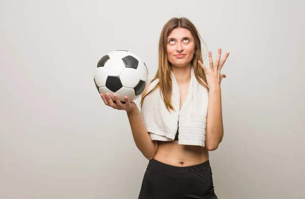 Young Fitness Russian Woman Very Scared Afraid Holding Soccer Ball — 스톡 사진