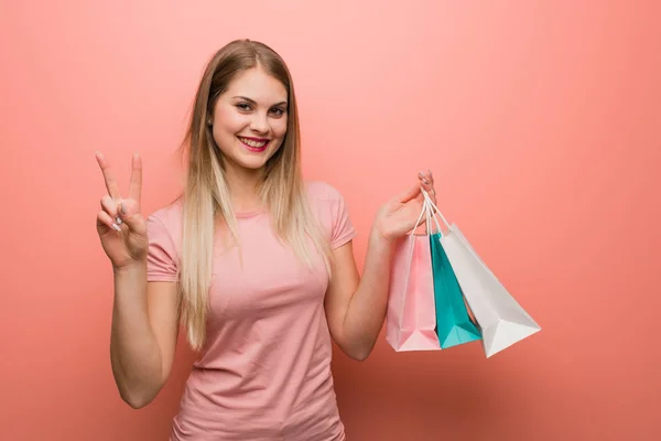 Young Pretty Russian Girl Showing Number Two She Holding Shopping — 스톡 사진