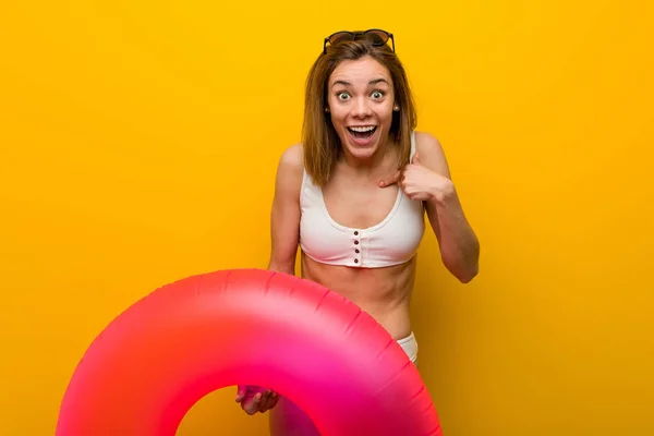 Young Woman Wearing Bikini Holding Inflatable Donut Surprised Pointing Herself — Stock Photo, Image