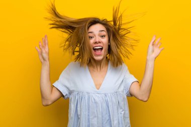Young pretty young woman celebrating a victory or success