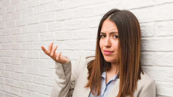 Young business woman confused and doubtful