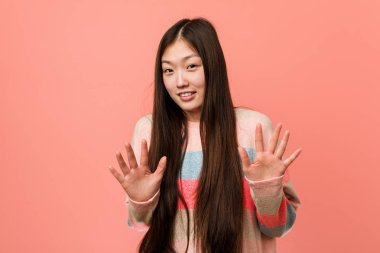 Genç, havalı Çinli kadın iğrenme hareketi gösteren birini reddediyor..