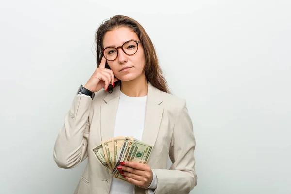 Young European Business Woman Holding Dollar Banknotes Pointing Her Temple — Stock Photo, Image