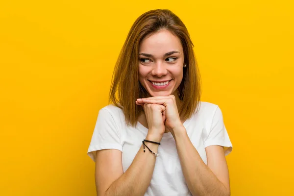 Young Natural Caucasian Woman Keeps Hands Chin Looking Happily Aside — 스톡 사진