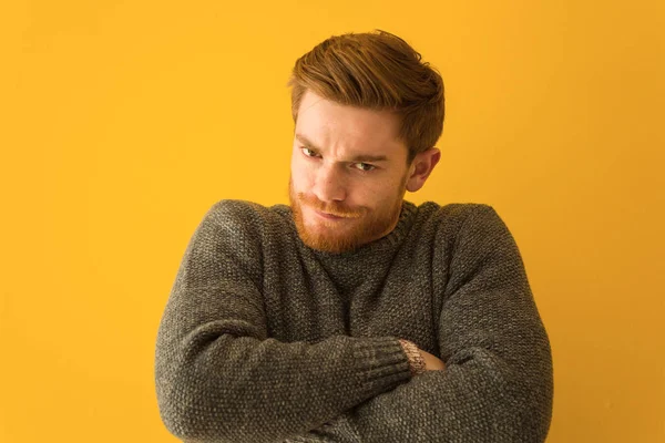 Young redhead man face closeup crossing arms relaxed