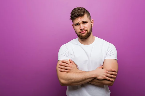 Young handsome caucasian man unhappy looking in camera with sarcastic expression.