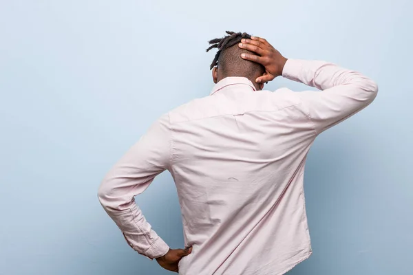 Young business african black man from behind thinking about something.