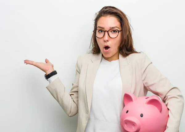 Young European Business Woman Holding Piggy Bank Impressed Holding Copy — Stock Photo, Image