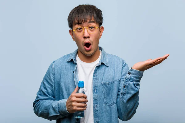 Young Chinese Man Holding Water Bottle Holding Something Palm Hand — 스톡 사진