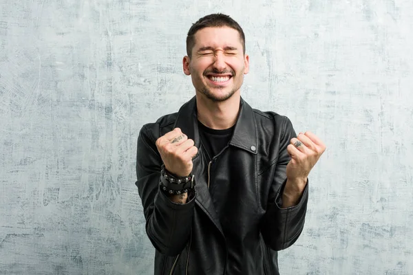 Young rocker man cheering carefree and excited. Victory concept.