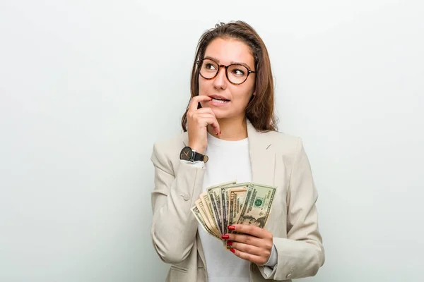 Young European Business Woman Holding Dollar Banknotes Relaxed Thinking Something — Stock Photo, Image