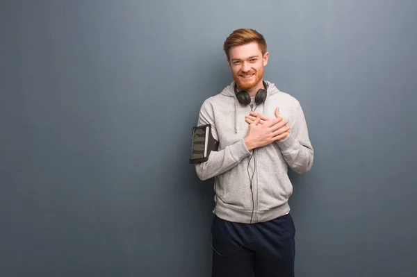 Young fitness redhead man doing a romantic gesture