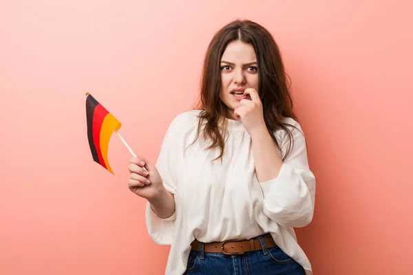 Young Curvy Size Woman Holding Germany Flag Biting Fingernails Nervous — 스톡 사진