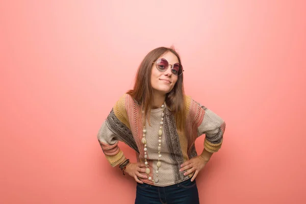 Young hippie woman on pink background scolding someone very angry