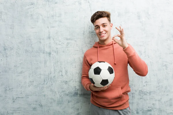 Young Sporty Man Holding Soccer Ball Cheerful Confident Showing Gesture — 스톡 사진