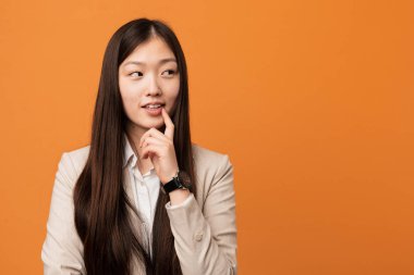 Genç Çinli kadın rahatlamış fotokopi odasına bakan bir şey düşünüyor..