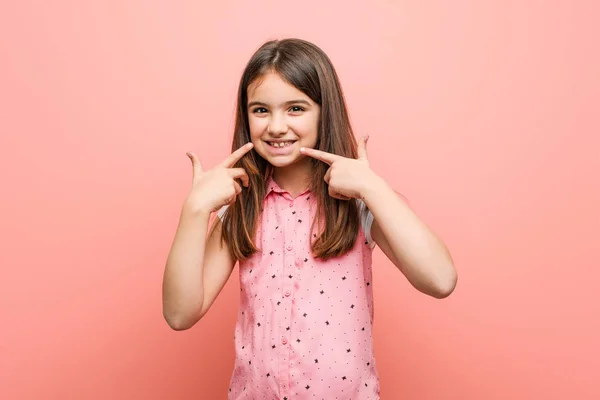 Cute Little Girl Smiles Pointing Fingers Mouth — Stock Photo, Image