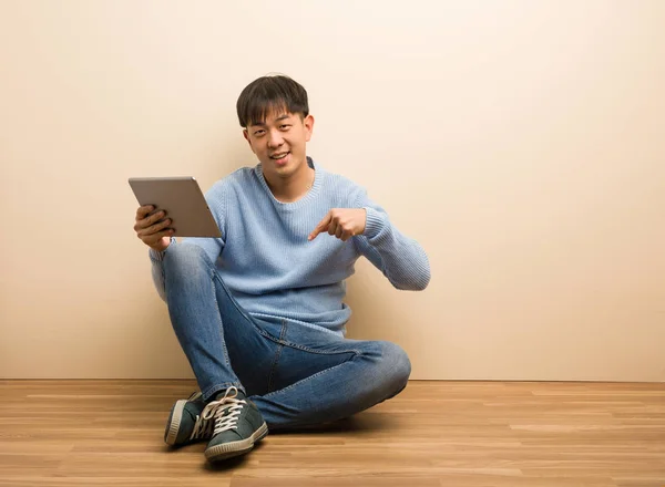 Young Chinese Man Sitting Using His Tablet Pointing Bottom Fingers — Stock Photo, Image