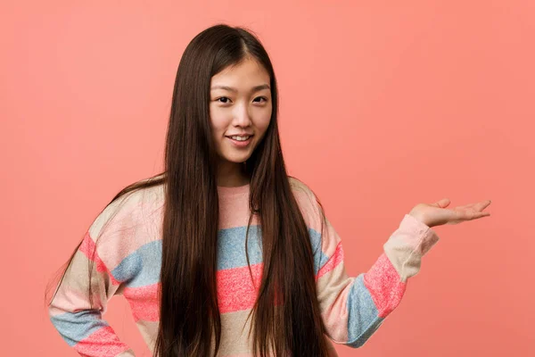 Young Cool Chinese Woman Showing Copy Space Palm Holding Another — 스톡 사진