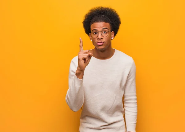 Jovem Homem Afro Americano Sobre Uma Parede Laranja Tendo Uma — Fotografia de Stock