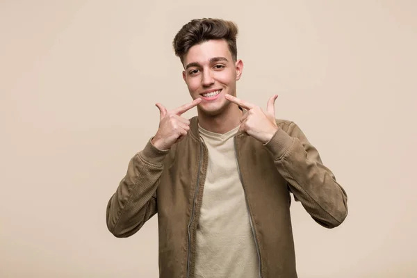 Young Caucasian Man Wearing Brown Jacket Smiles Pointing Fingers Mouth — 스톡 사진