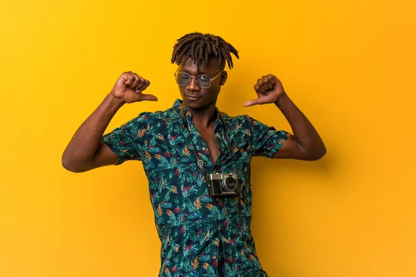 Young black rasta man wearing a vacation look feels proud and self confident, example to follow.