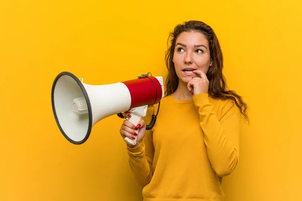 Young European Woman Holding Megaphone Relaxed Thinking Something Looking Copy — Stock Photo, Image