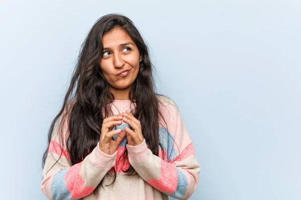 Young fashion indian woman making up plan in mind, setting up an idea.